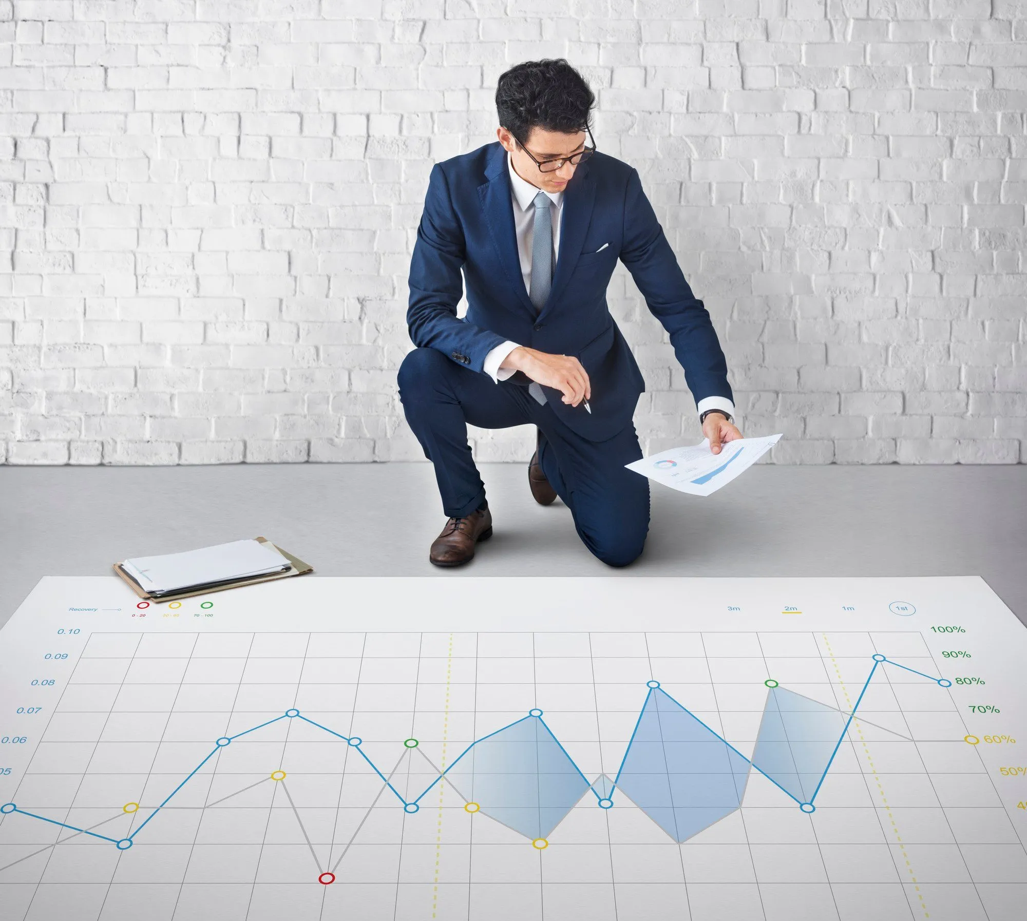Financial analyst reviewing charts and reports
