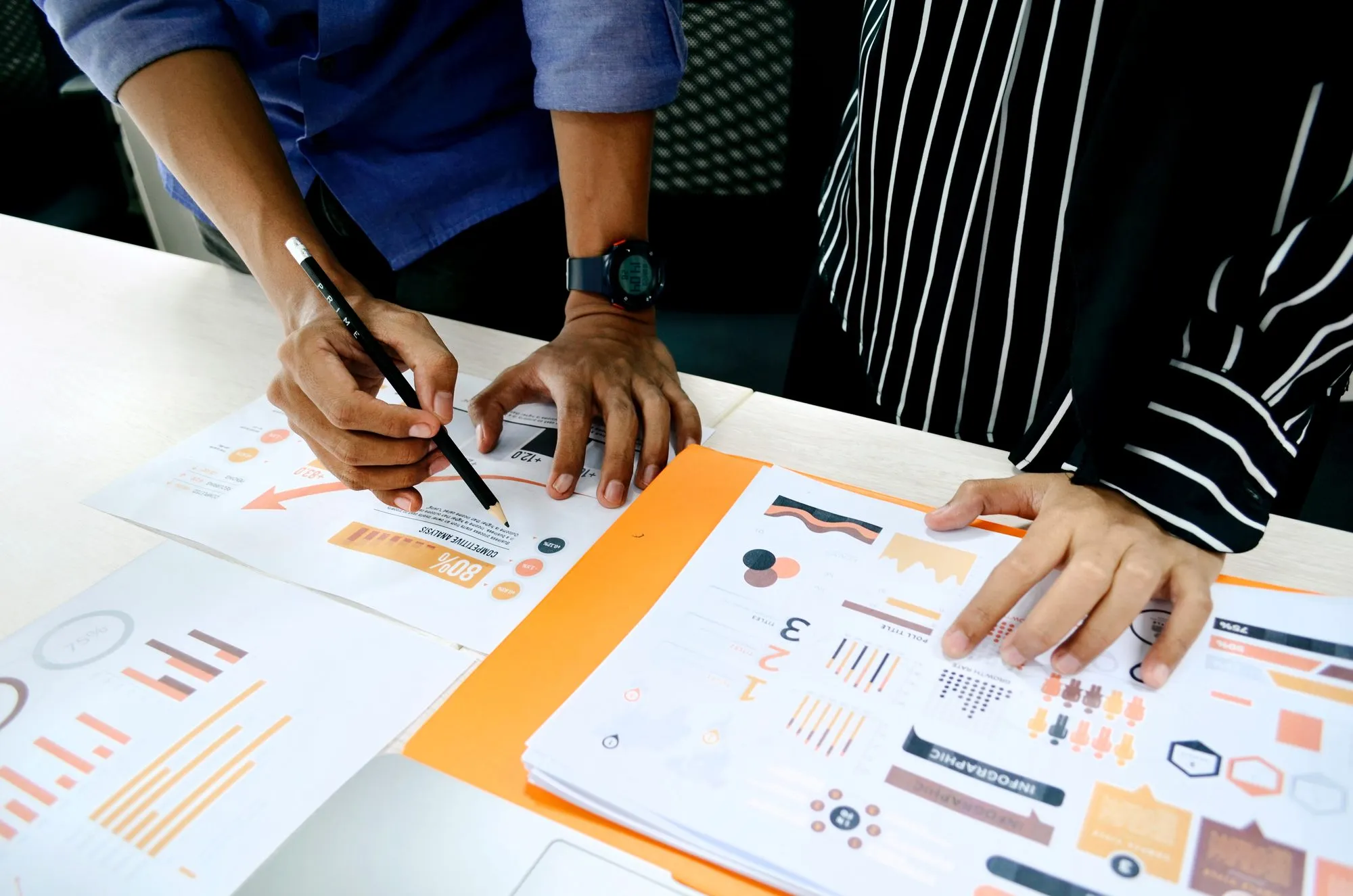 A team working with printed business charts